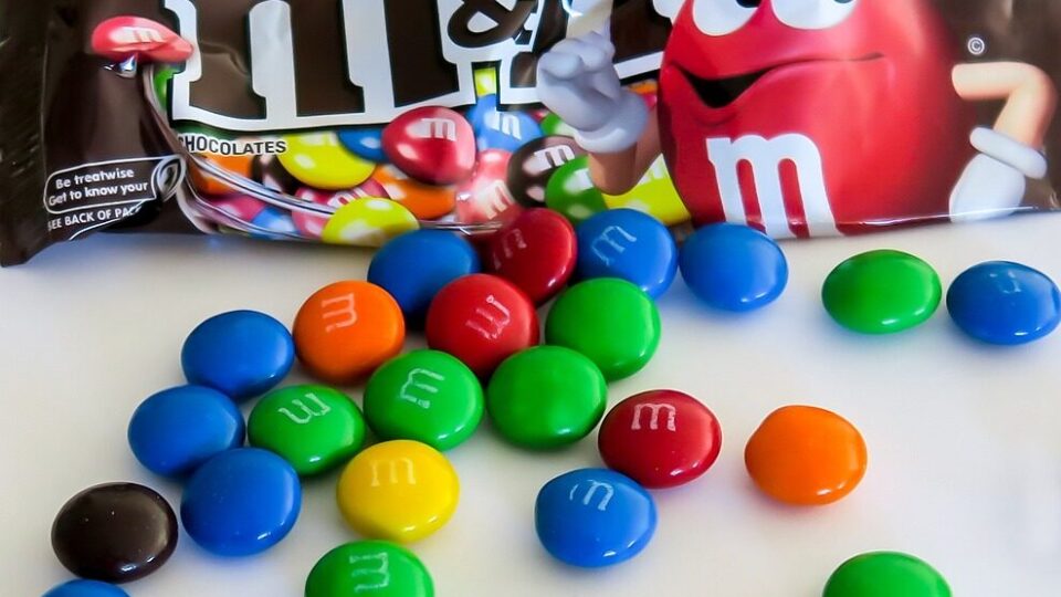 sugary m&ms with the mascot giving a thumbs down